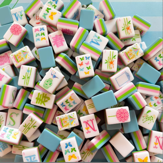 Sweet Pastel Bamboo Butterfly acrylic mahjong tile set piled in a blue gift box - colorful pastel American mahjong tiles with butterfly and bamboo designs - mahjong gift set for birthdays, holidays, and corporate gifts, NYC luxury gift shop, nationwide delivery