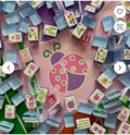 Blue Luck Ladybug American mahjong tile set arranged in a circle around a pink ladybug logo - acrylic tiles with racks displayed flat lay - mahjong gift set from NYC luxury gift shop, nationwide delivery