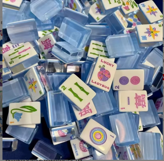 Blue Luck Ladybug acrylic mahjong tiles scattered in a pile - NMJL compatible American mahjong set featuring Lucky Ladybug joker tile, dot tiles, bamboo tiles, and crak tiles - corporate gifts and holiday mahjong gift sets