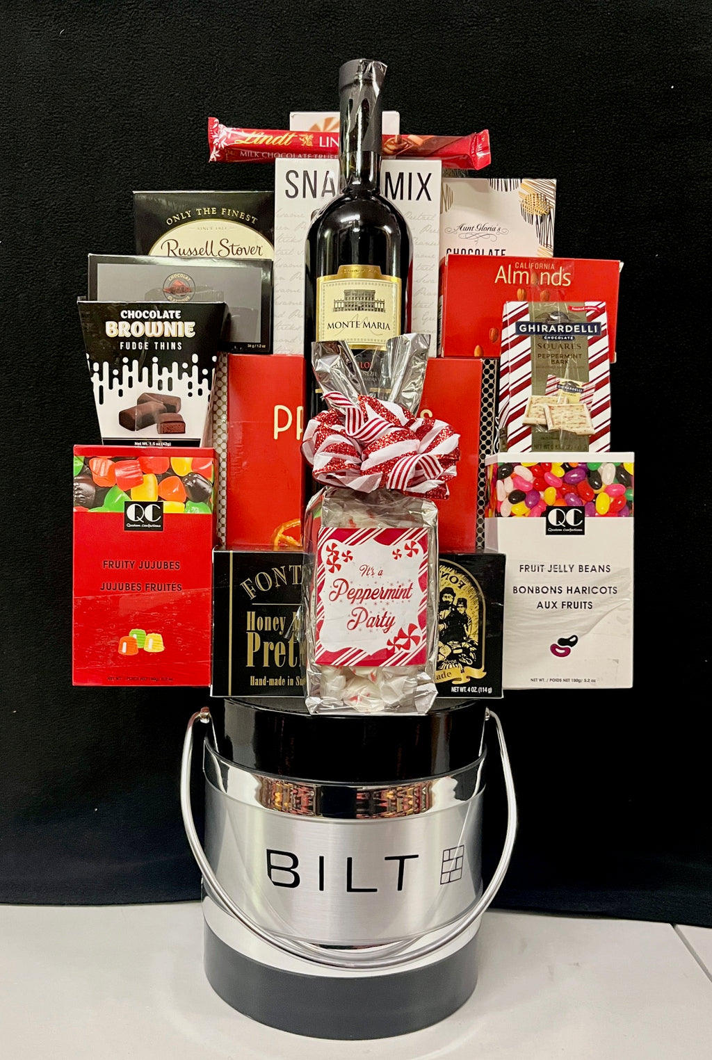 Customized corporate logo ice bucket gift with wine and assorted gourmet foods in red packaging, a branded client or holiday gift with NYC and nationwide delivery
