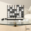 Umbra Stax Four-in-a-Row game with a black frame and frosted black and white playing pieces