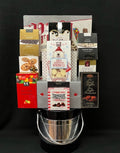 Black and silver holiday gourmet ice bucket filled with festive chocolates and treats, a corporate gift for NYC and Long Island with nationwide delivery
