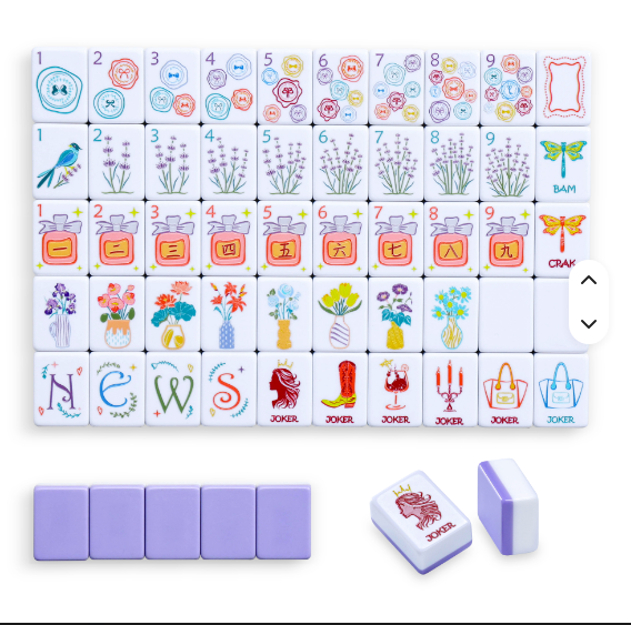 Lady Floral Theme American mahjong tile set laid out showing all suits - dot, bamboo, crak with perfume bottles, flower tiles, NEWS wind tiles, and fashion joker tiles featuring handbags, boots, and candelabras - NMJL compatible mahjong gift, Corey Paige, Bespoke Mahjong, My Fair Mahjong, Oh My Mahjong - NYC luxury gift shop
