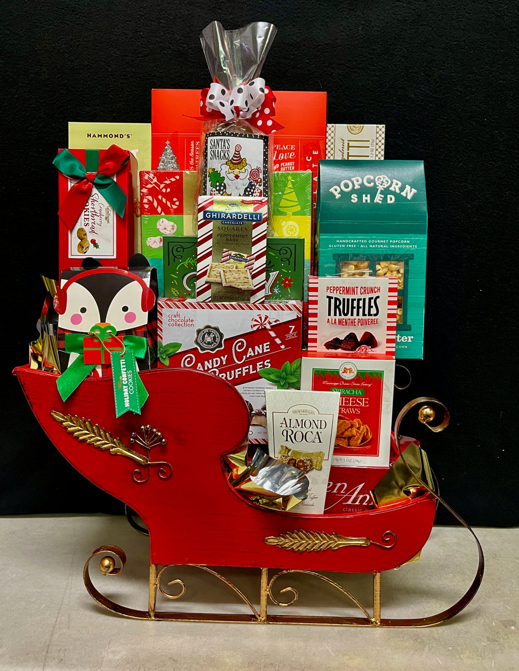 Scarlet Sophisticate holiday sleigh corporate gift basket - luxury red decorative keepsake sleigh filled with chocolates, biscotti, caramels, and savory treats, delivered nationwide and to New York City NYC - perfect for corporate holiday gifts, client appreciation, Christmas and Chanukah gifting, and employee appreciation