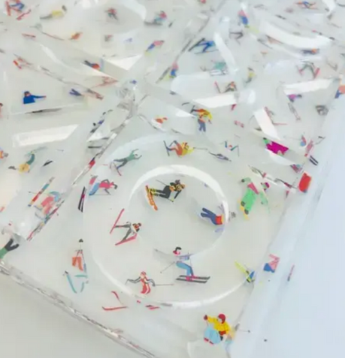 Close-up of acrylic Ski Tic-Tac-Toe board featuring colorful skier figures embedded in clear acrylic - decorative game gift for home, Long Island gift store
