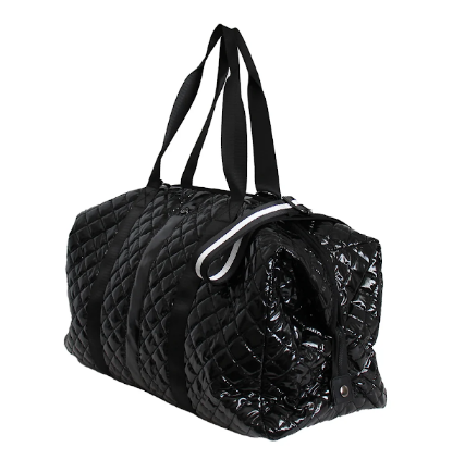 A black quilted duffel bag with a glossy patent finish on the front panel, black shoulder straps, and a white zipper pull